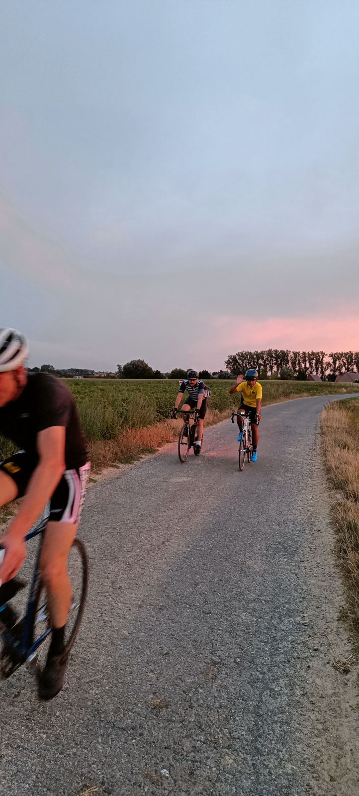 Group of cyclists approaching on countryside road