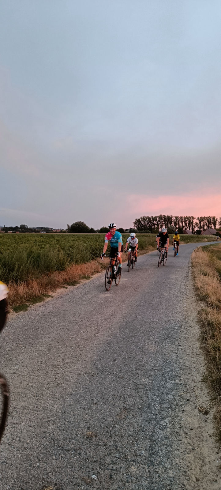 Group of cyclists approaching on countryside road